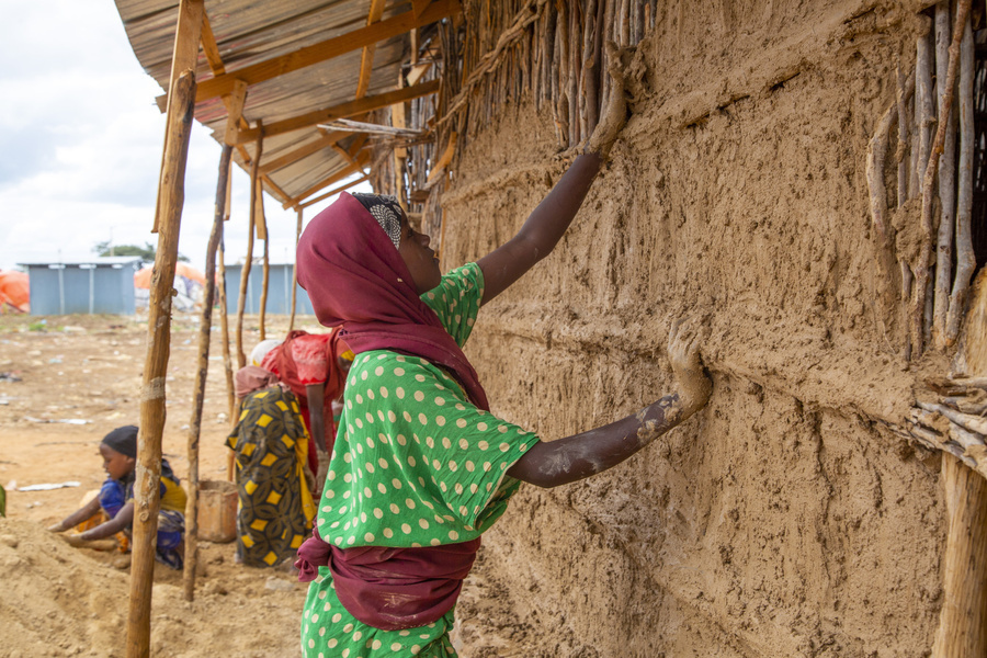 Woman building a house in Somalia