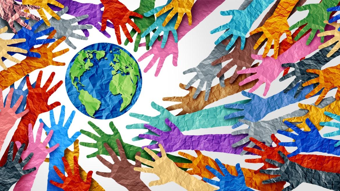 Colourful paper hands surrounding a globe