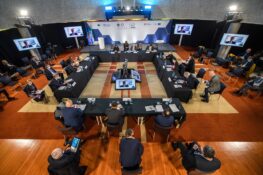 People Gathered Round A Table In A Conference Room